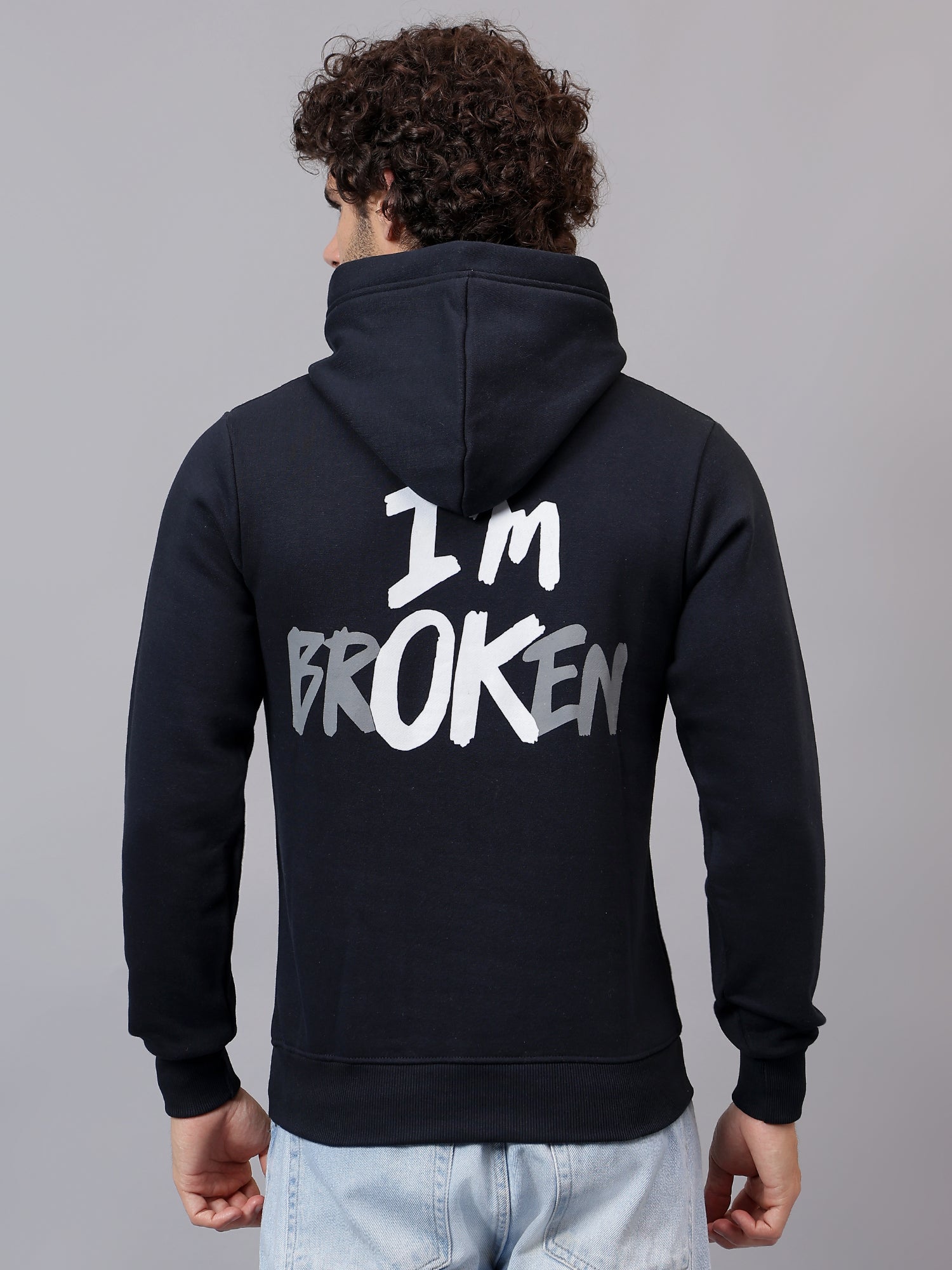 Person wearing a  Athfuel hoodie with 'I'm Broken' text on the back against a gray background Blue
