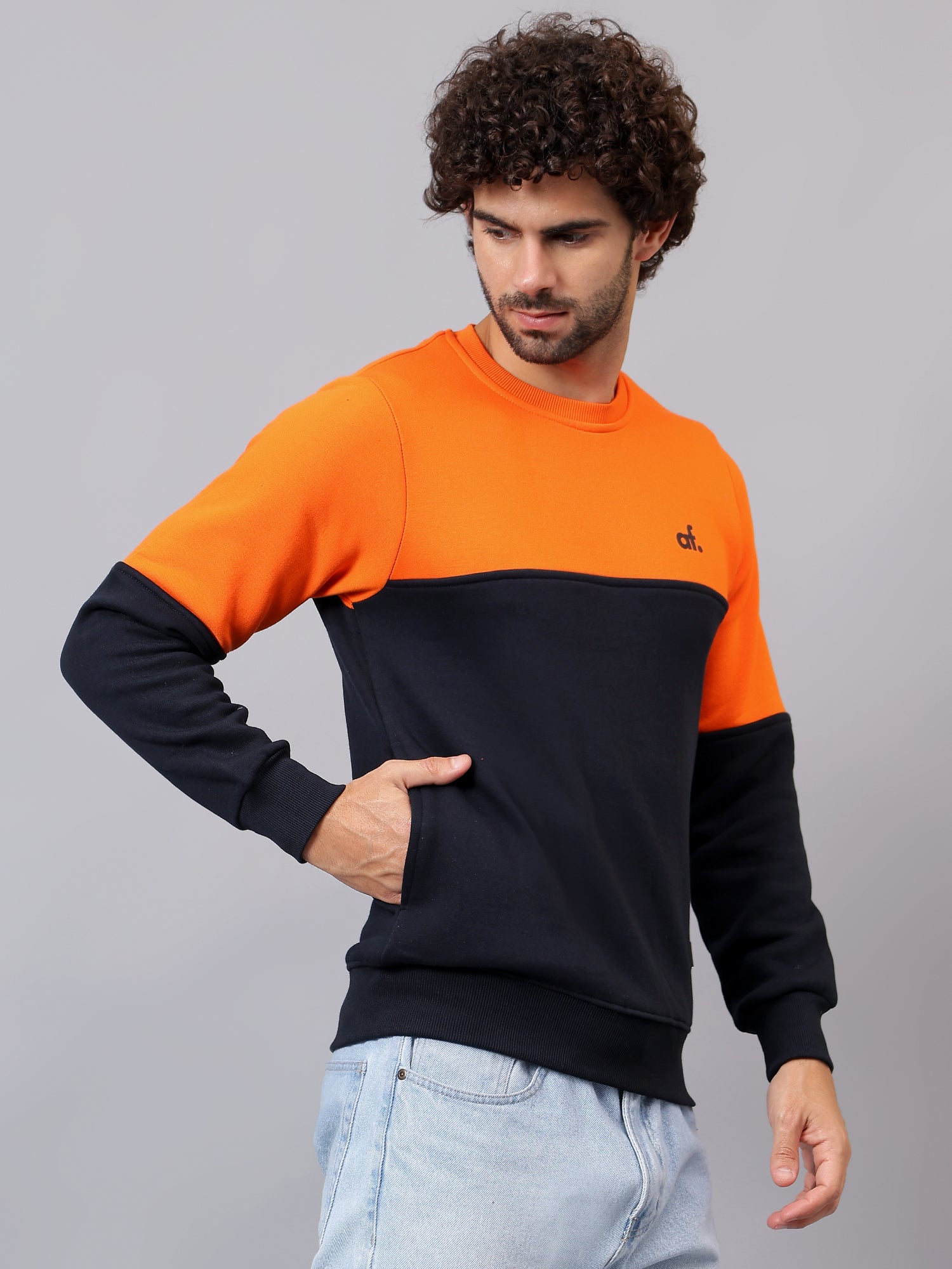 Model wearing Athfuel Merge two-tone sweatshirt styled casually in Orange-NavyBlue