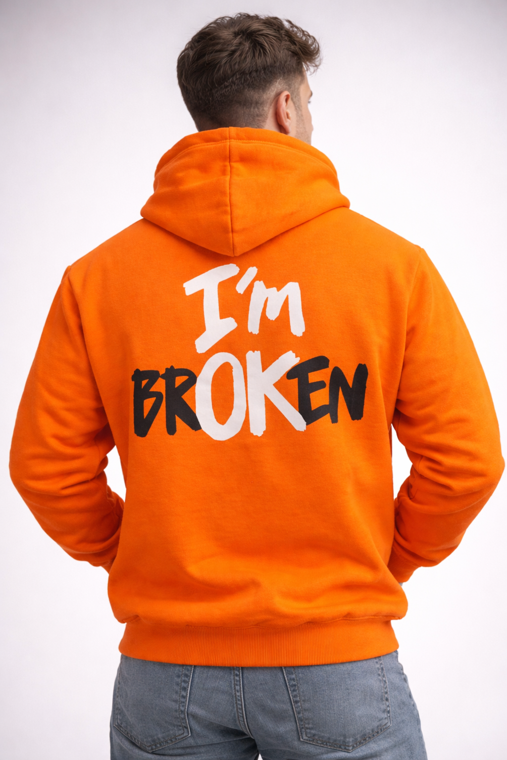 Back Side of Man wearing Athfuel 'Im OK' printed hoodie in color Orange